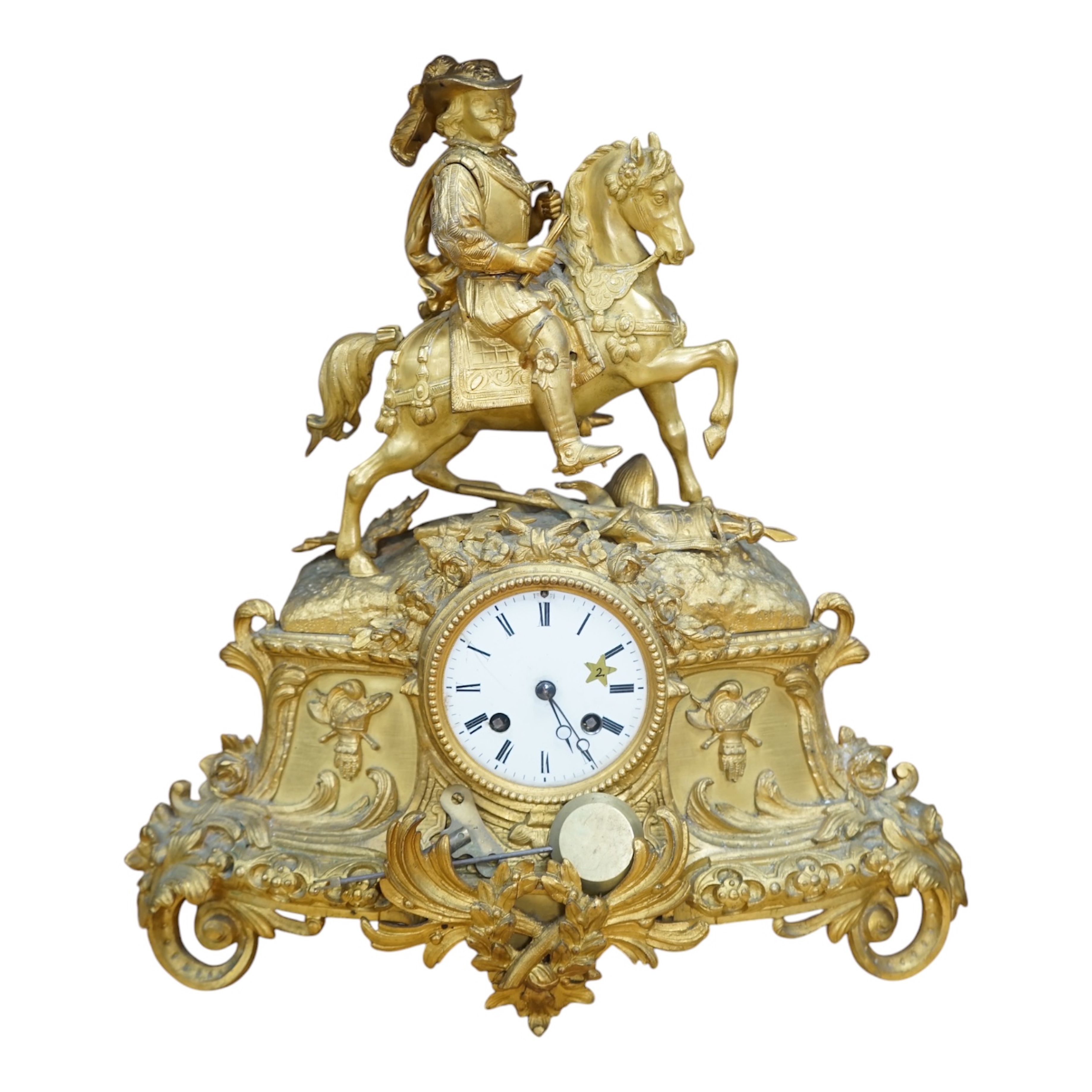 A late 19th century French ormolu mantel clock surmounted with a cavalier on horseback, key and pendulum, 38cm. Condition - fair to good